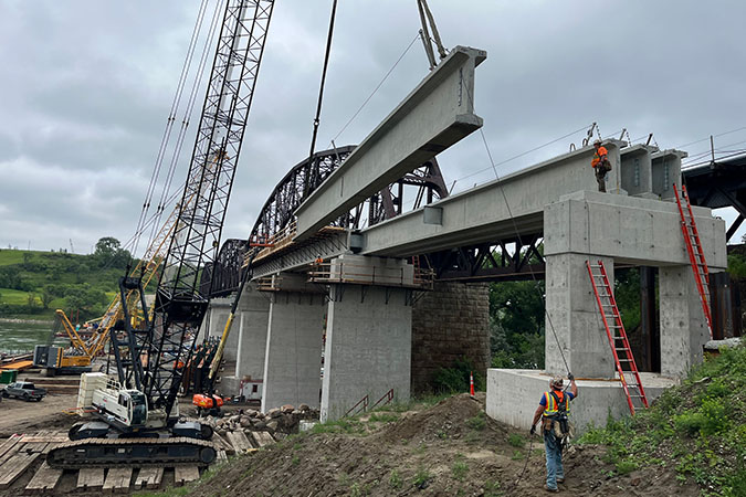 Crews erect the precast girders for span 11. 